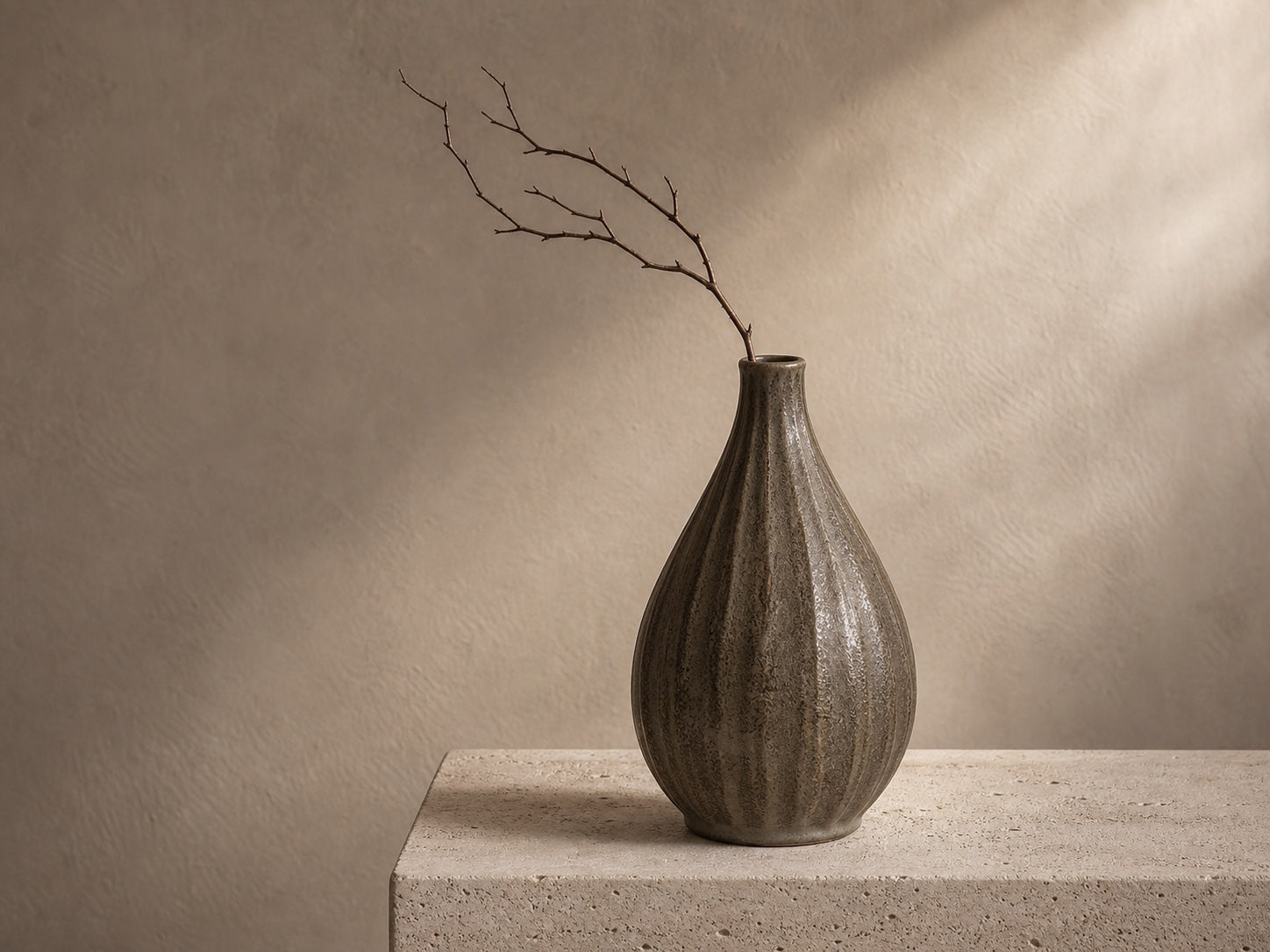 A considered group of stems arranged in a narrow opening vase